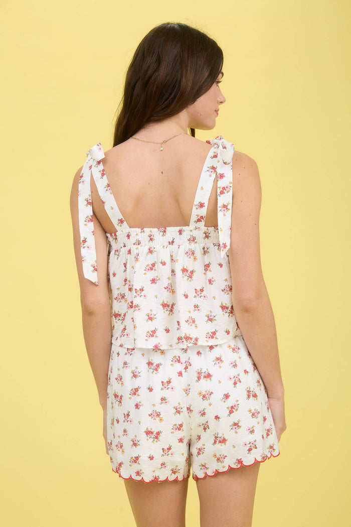 Stylish FLORAL CONTRAST SCALLOP TRIM TIE STRAP BLOUSE with adjustable tie straps and flattering smocked back.