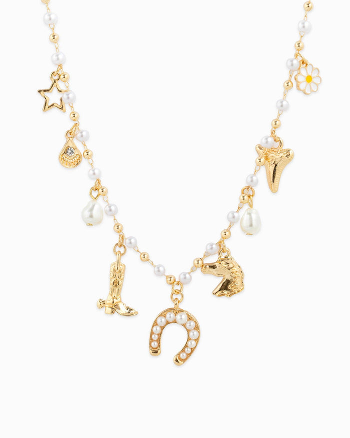 Close up view of gold Western Icon Charm Necklace with white background