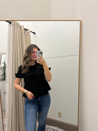 Stylishly wearing the Black Rhinestone Dotted Tie-Front Blouse for Elegant Style, perfect for any occasion.