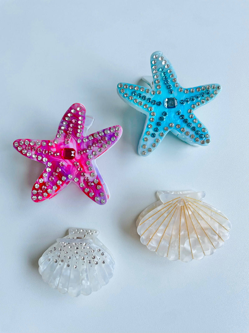 Close-up of Coastal Hair Claw Clips – A collection of seashell and ocean-inspired claw clips in soft coastal hues.