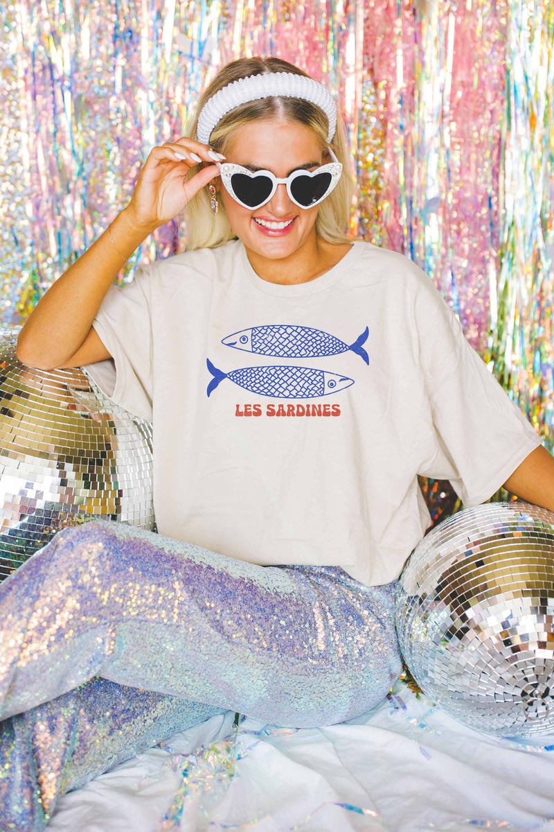 Close-up of the sardines print artwork on a cotton oversized t-shirt.

